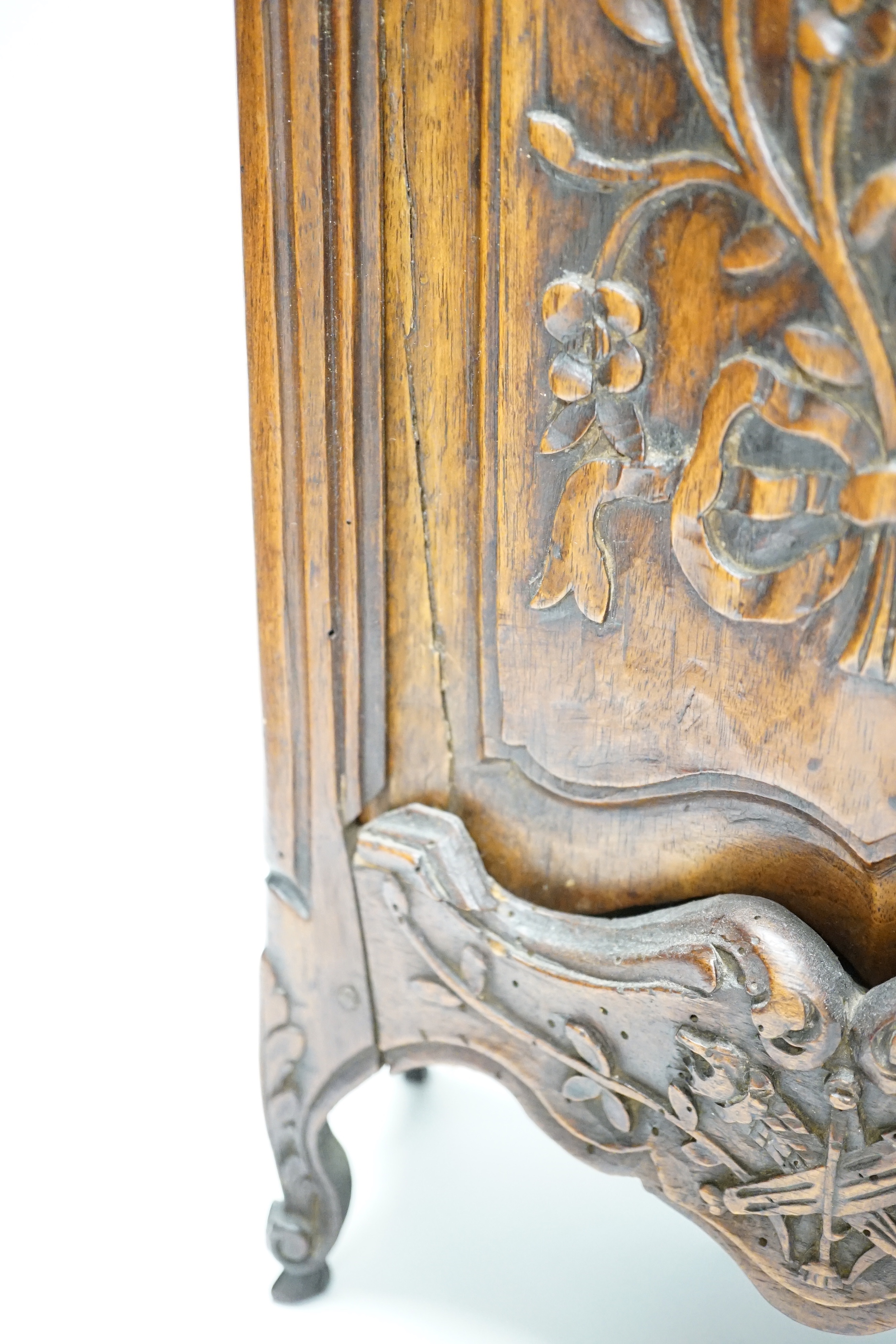 An 18th century French carved walnut miniature armoire/hutch with sliding front panel, 50cm high